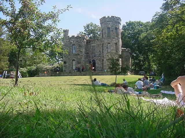 A castle with a large green area in front of it